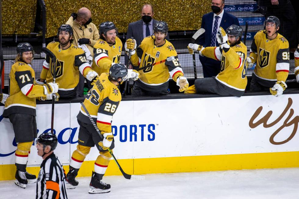 Golden Knights center Mattias Janmark (26) is cheered on by teammates after scoring his first g ...