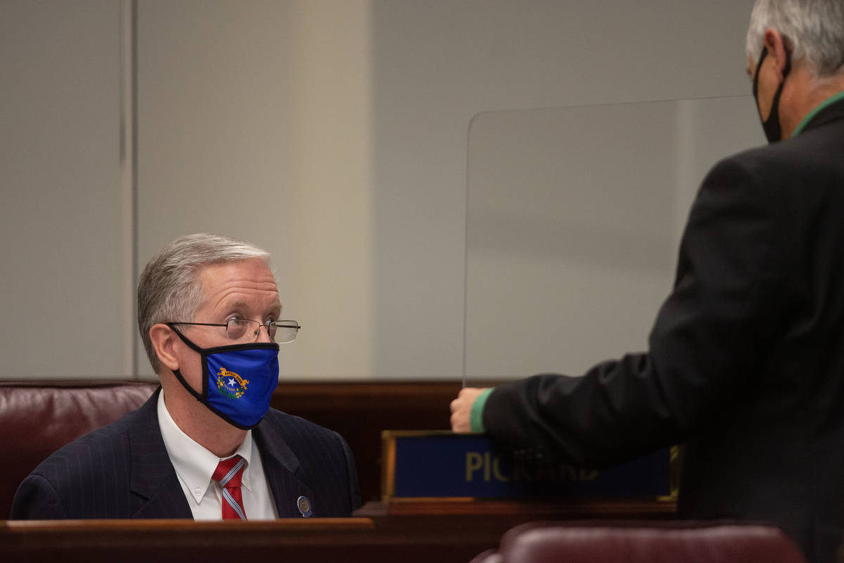 State Senator Keith Pickard speaks with Minority Leader James Settelmeyer inside the Legislatur ...