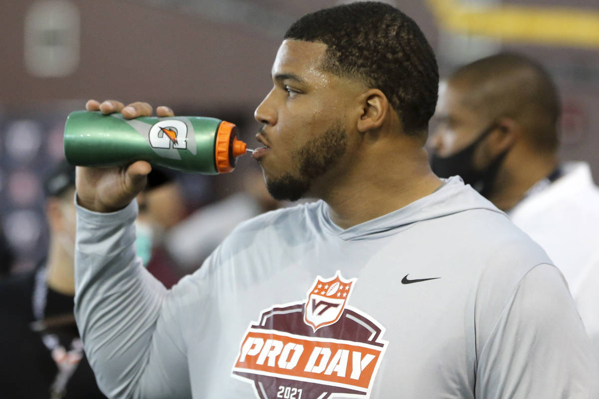Christian Darrisaw lineman pauses for a drink during Virginia Tech pro day in Blacksburg, Va., ...