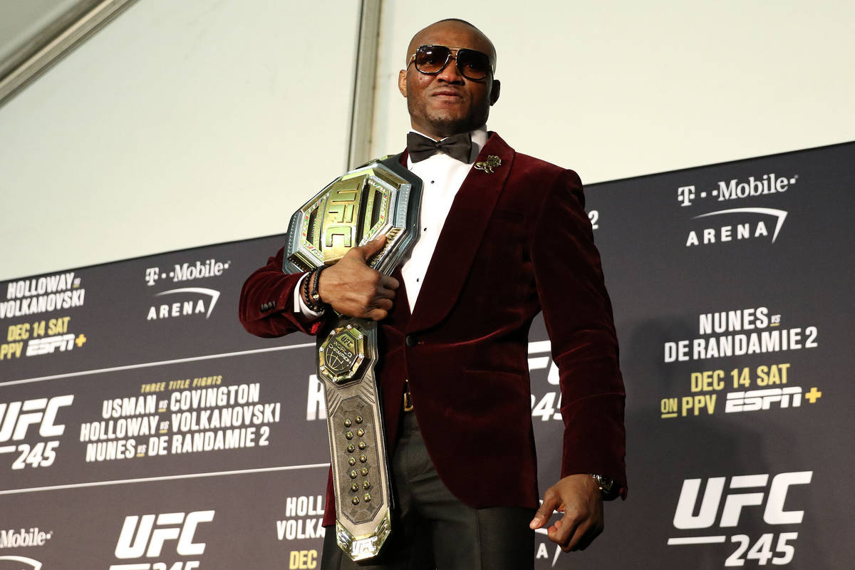 UFC welterweight champion Kamaru Usman poses with his belt during the UFC 245 post-fight press ...