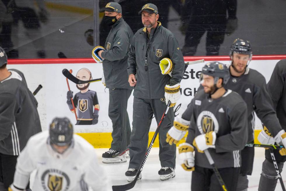 Vegas Golden Knights head coach Pete DeBoer looks on as the team disperses from a meeting on th ...