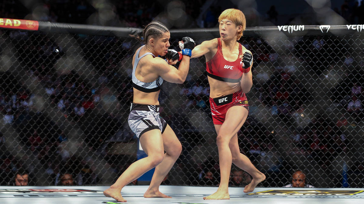 Ariane Carnelossi, left, takes a punch from Liang Na, right, during a UFC 261 mixed martial art ...