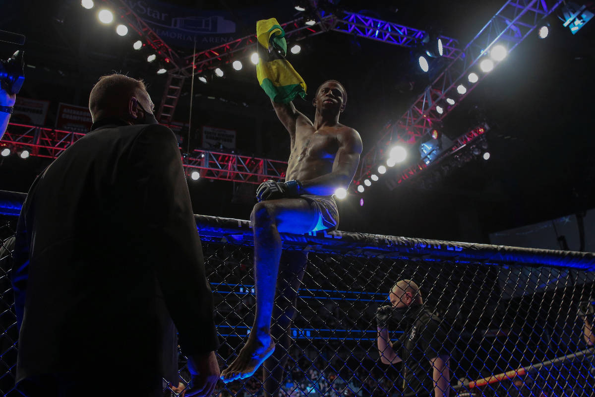 Randy Brown hops atop the octagon fence after winning his UFC 261 mixed martial arts bout, Satu ...