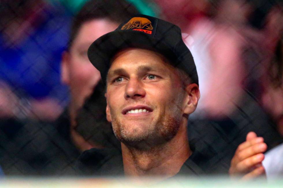 Tampa Bay Buccaneers quarterback Tom Brady watches a UFC 261 mixed martial arts bout, Saturday, ...