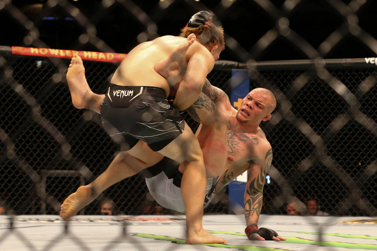 Anthony Smith, right, hits the mat while charged by Jimmy Crute during a UFC 261 mixed martial ...