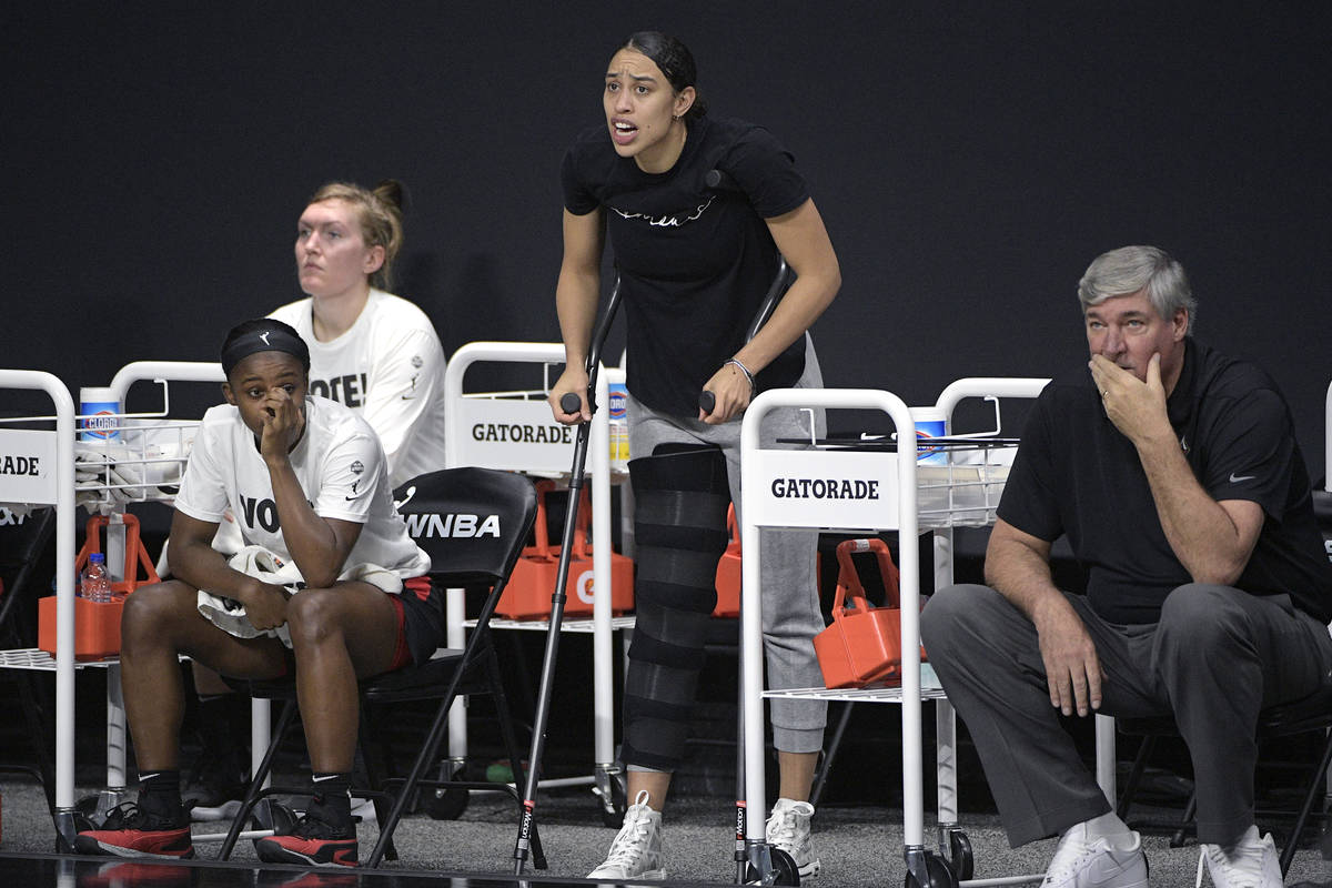 Las Vegas Aces forward Dearica Hamby, center, calls out words of encouragement from the bench a ...