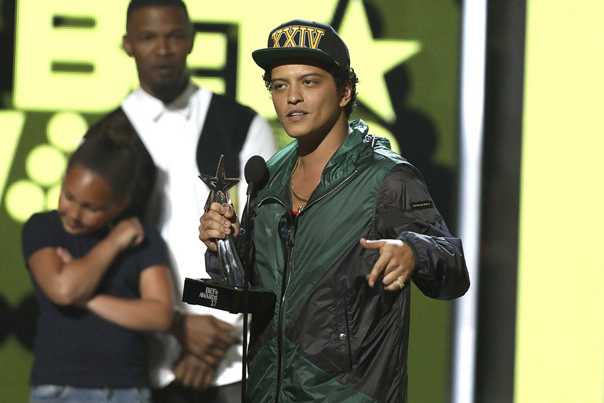 Bruno Mars accepts the award for best male R&B/pop artist at the BET Awards at the Microsof ...