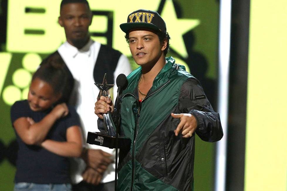 Bruno Mars accepts the award for best male R&B/pop artist at the BET Awards at the Microsof ...