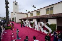 Maria Bakalova, from left, Andra Day and Regina King are interviewed and Marlee Matlin walks th ...