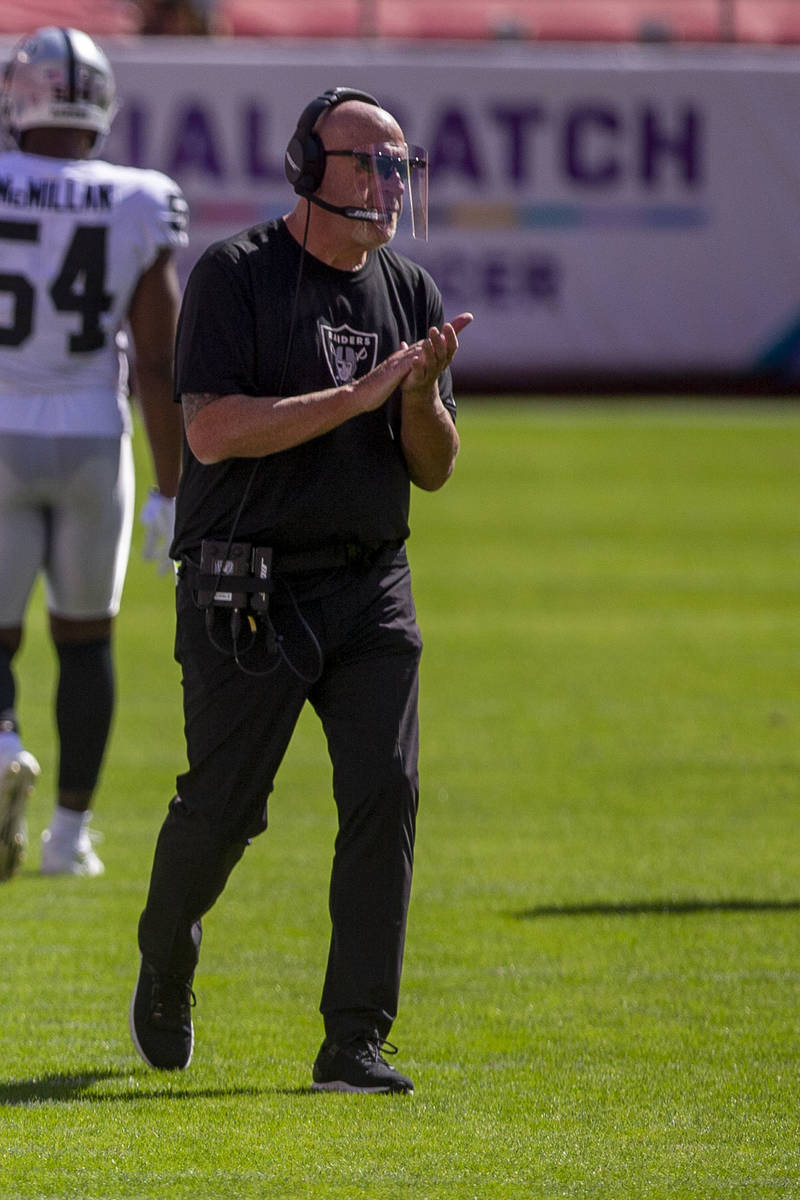Las Vegas Raiders offensive line coach Tom Cable applauds from the sideline during the second q ...