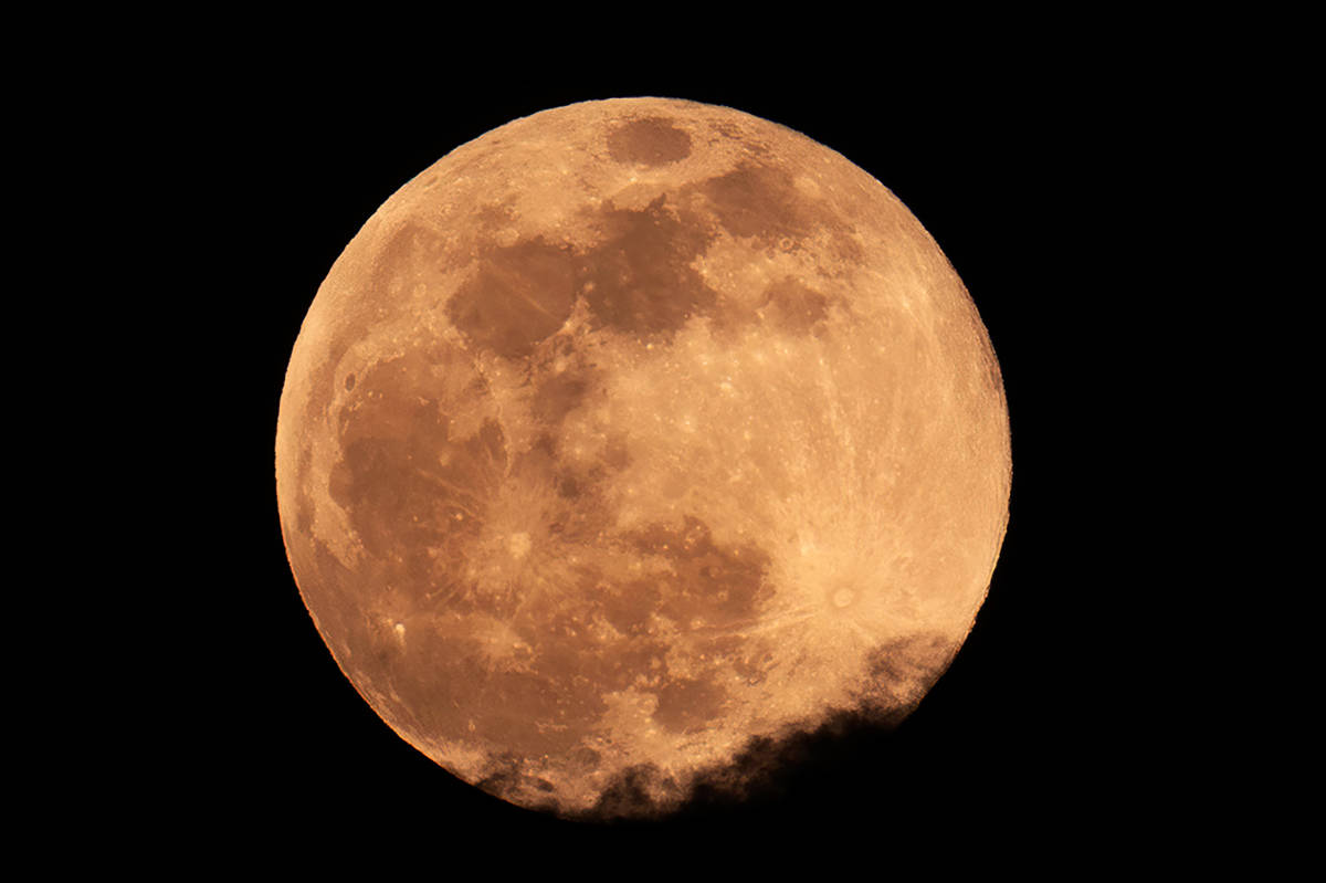 The Super Pink Moon south of the Strip above the clouds on Monday, April 26, 2021 in Las Vegas. ...
