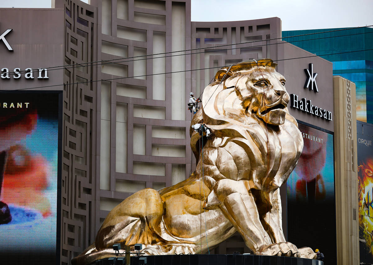 Workers buff the MGM lion statue outside the MGM Grand on Tuesday, April 27, 2021, in Las Vegas ...