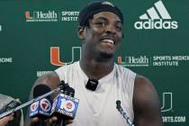 FILE - Miami NCAA college football defensive linemen Gregory Rousseau talks to the media after ...