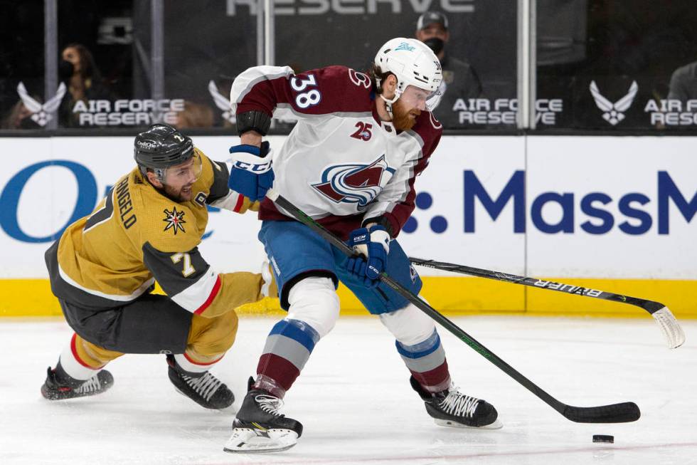 Golden Knights defenseman Alex Pietrangelo (7) dives for the puck while Avalanche center Liam O ...