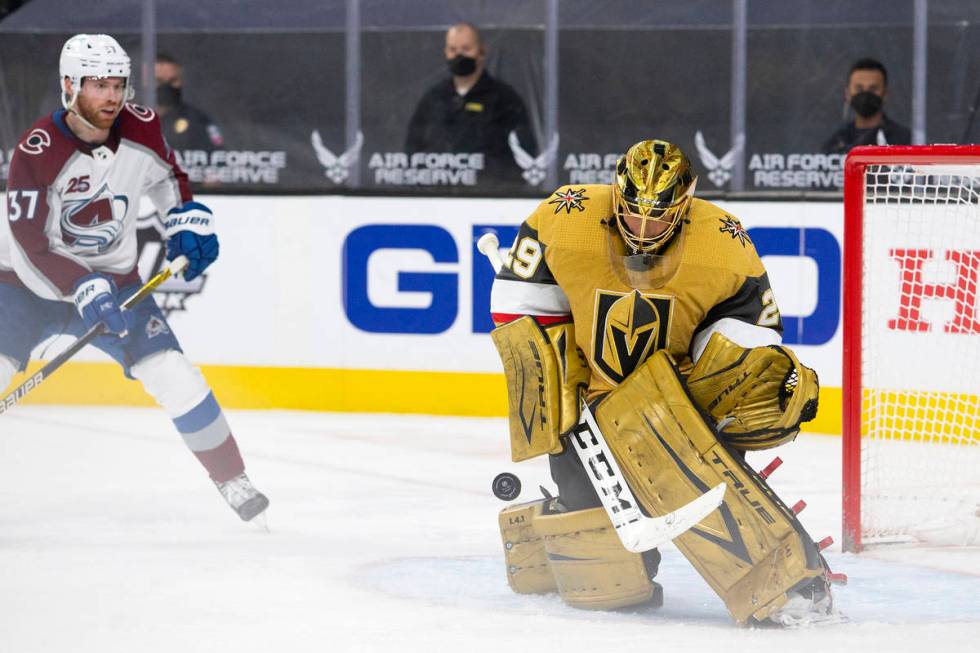 Golden Knights goaltender Marc-Andre Fleury (29) makes a save while Avalanche left wing J.T. Co ...