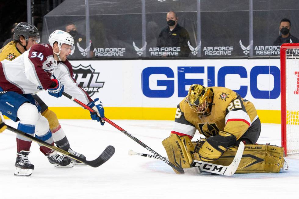 Avalanche defenseman Jacob MacDonald (34) attempts a goal while Golden Knights goaltender Marc- ...