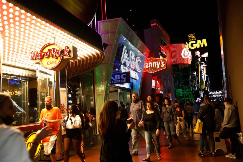 People walk along the Las Vegas Strip,, Friday, March 19, 2021, in Las Vegas. (Chitose Suzuki / ...