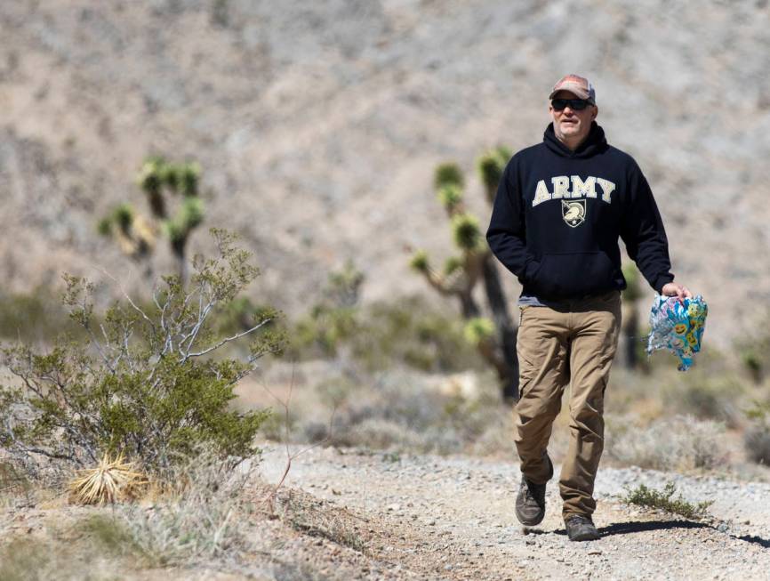 Bill Daniels retrieves stray balloons on Saturday, April 17, 2021, in Las Vegas. His 15-year-ol ...