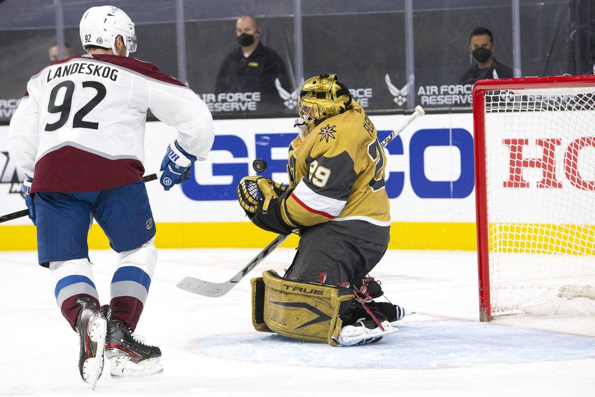 Golden Knights goaltender Marc-Andre Fleury (29) makes a save while Avalanche left wing Gabriel ...