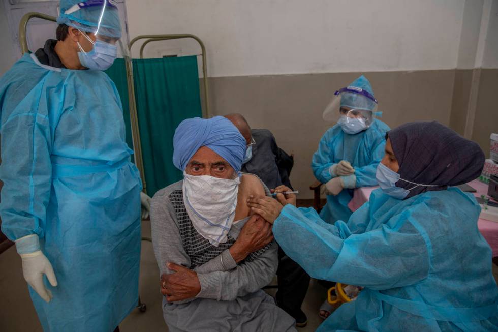 A Kashmiri man receives the COVISHIELD vaccine for COVID-19 at a primary health center in Srina ...