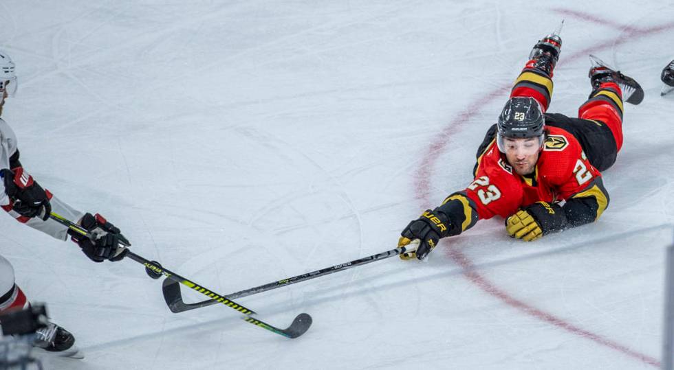 Golden Knights defenseman Alec Martinez (23) dives for a puck versus the Arizona Coyotes durin ...