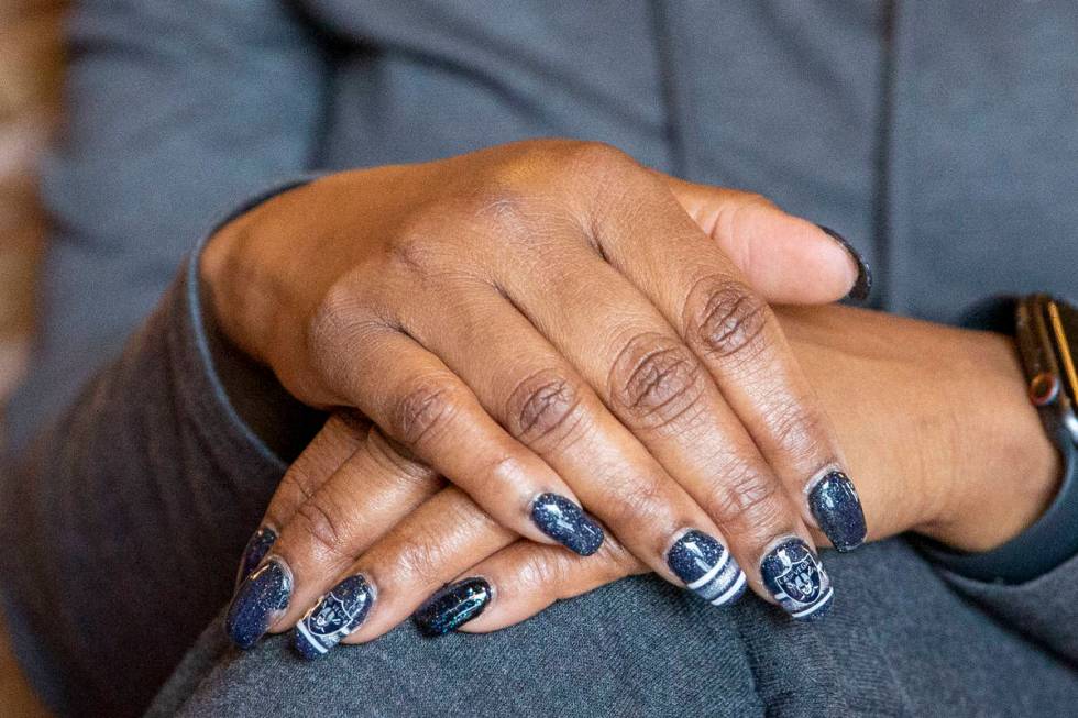Denean Vaughn, who was selected as the Raiders Fan of the Year, shows off her manicure at the R ...