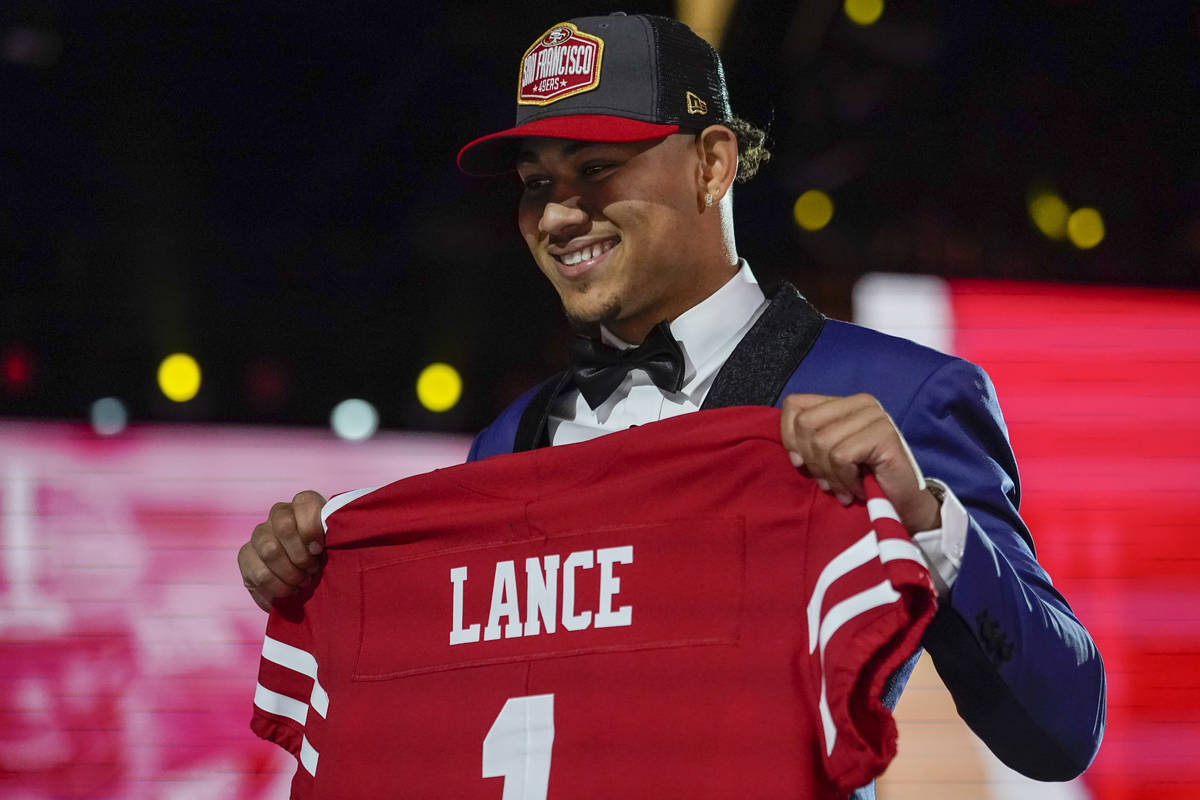 North Dakota State quarterback Trey Lance holds a San Francisco 49ers jersey after being chosen ...