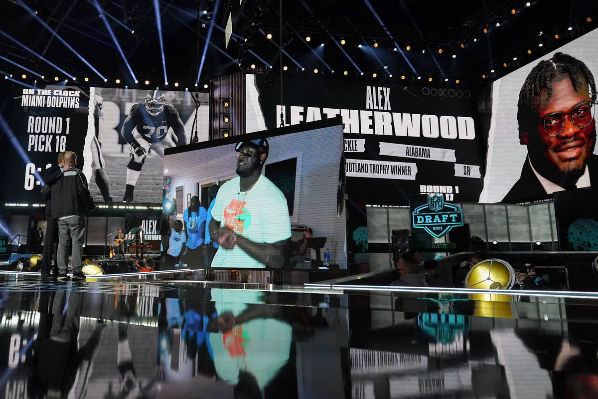 An image of Alabama tackle Alex Leatherwood is displayed on stage after he was chosen by the La ...