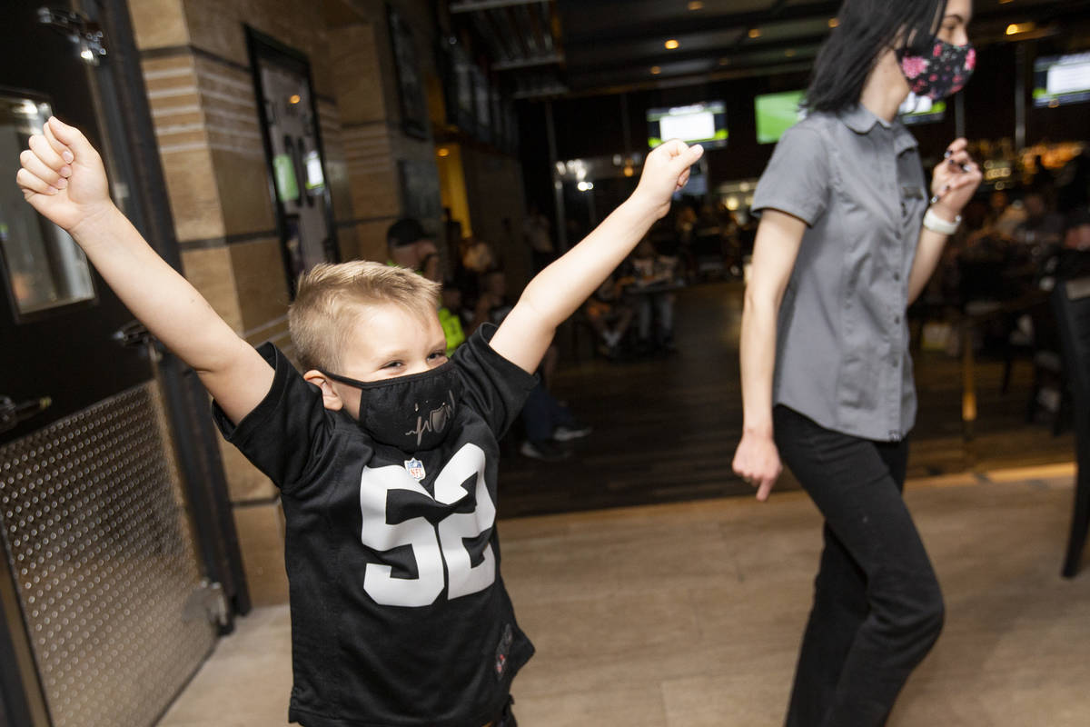 Benjamin Perks, 5, of Las Vegas, cheers right before the Raiders announced their first round NF ...
