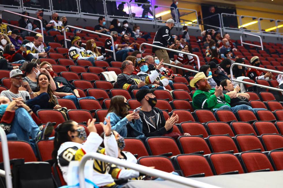 Golden Knights fans cheer at the start of an NHL hockey game against the Arizona Coyotes at Gil ...