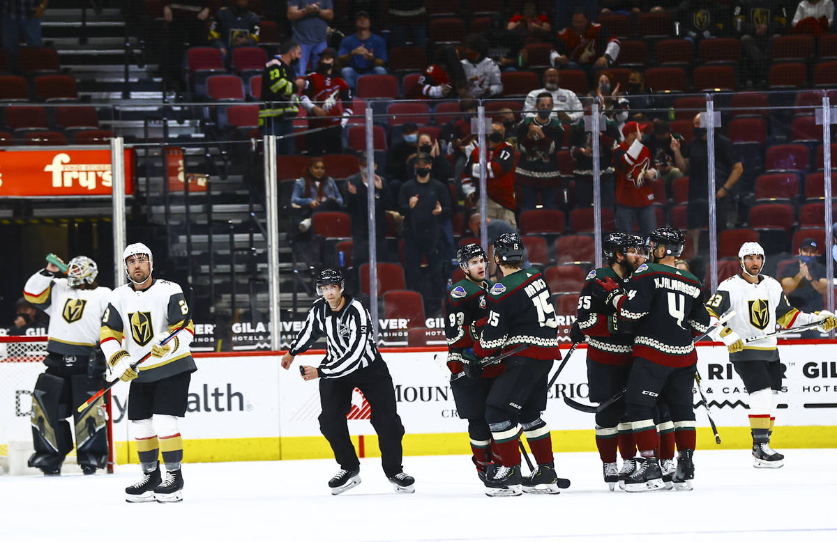 The Arizona Coyotes celebrate after scoring against the Golden Knights during the first period ...