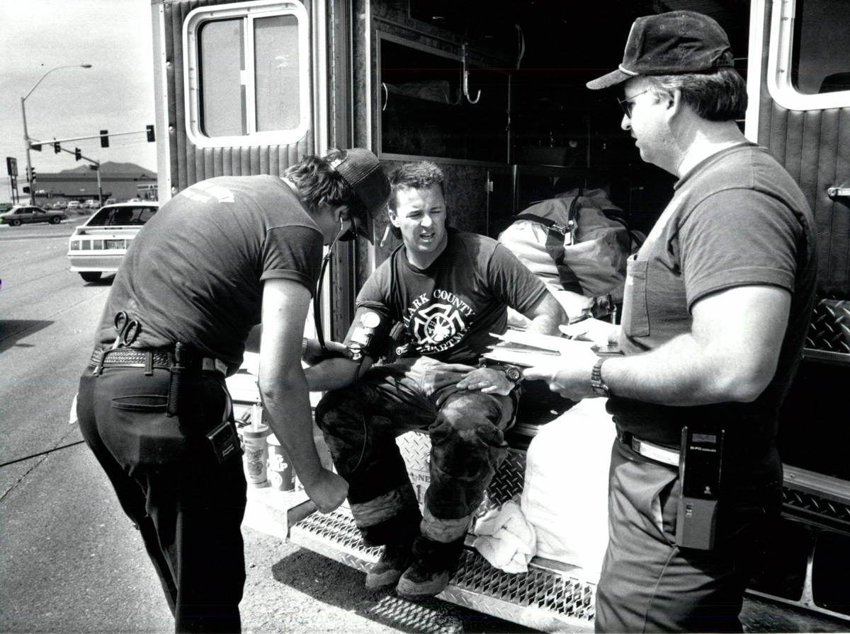 Firefighter Kevin Steele (center) has his pulse checked May 6, 1991, after a chlorine leak in H ...