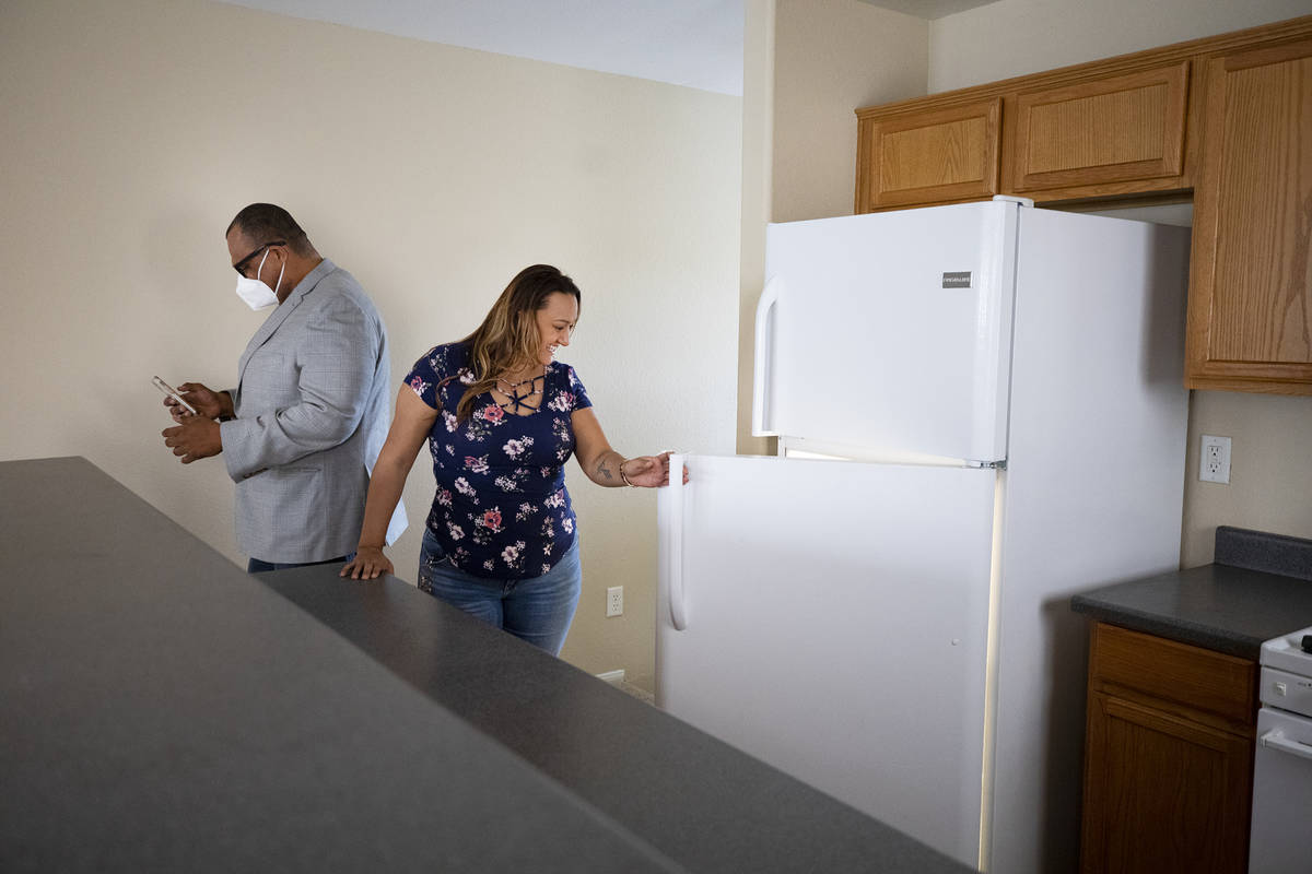 Realtor Cassidy Cotten, left, shows a home to first-time homebuyer Amy Phinsee, right, at a hom ...
