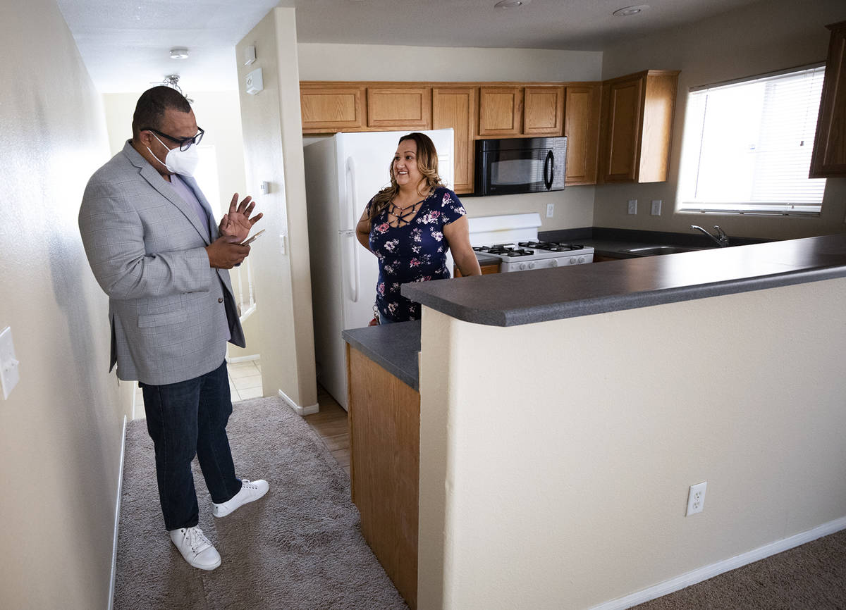 Realtor Cassidy Cotten, left, shows a home to first-time homebuyer Amy Phinsee, right, at a hom ...
