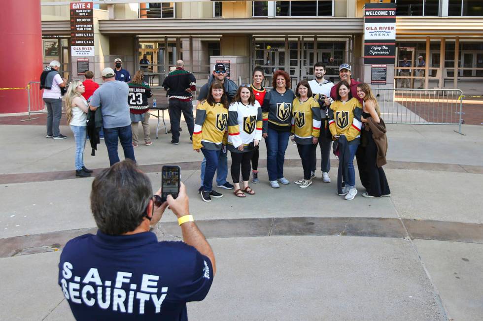 Golden Knights fans pose for a photo before the start of an NHL hockey game against the Arizona ...