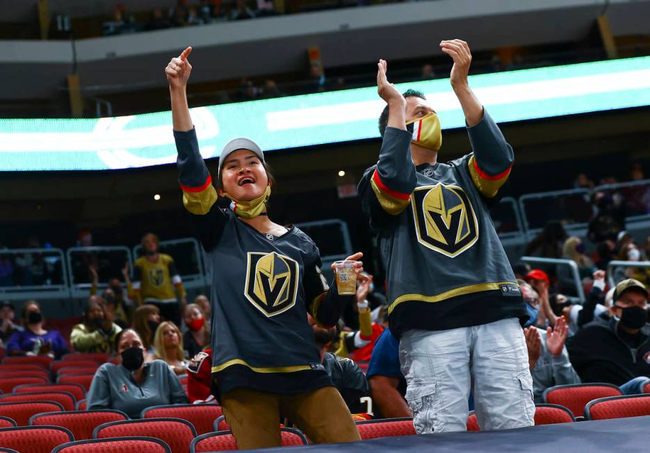 Golden Knights fans cheer during the second period of an NHL hockey game against the Arizona Co ...