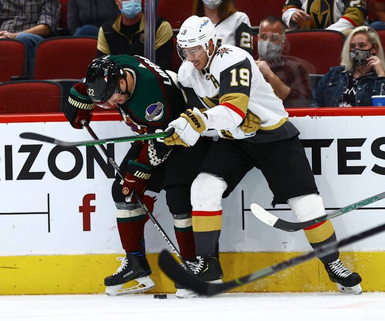 Golden Knights' Reilly Smith (19) and Arizona Coyotes' Johan Larsson (22) battle for the puck d ...