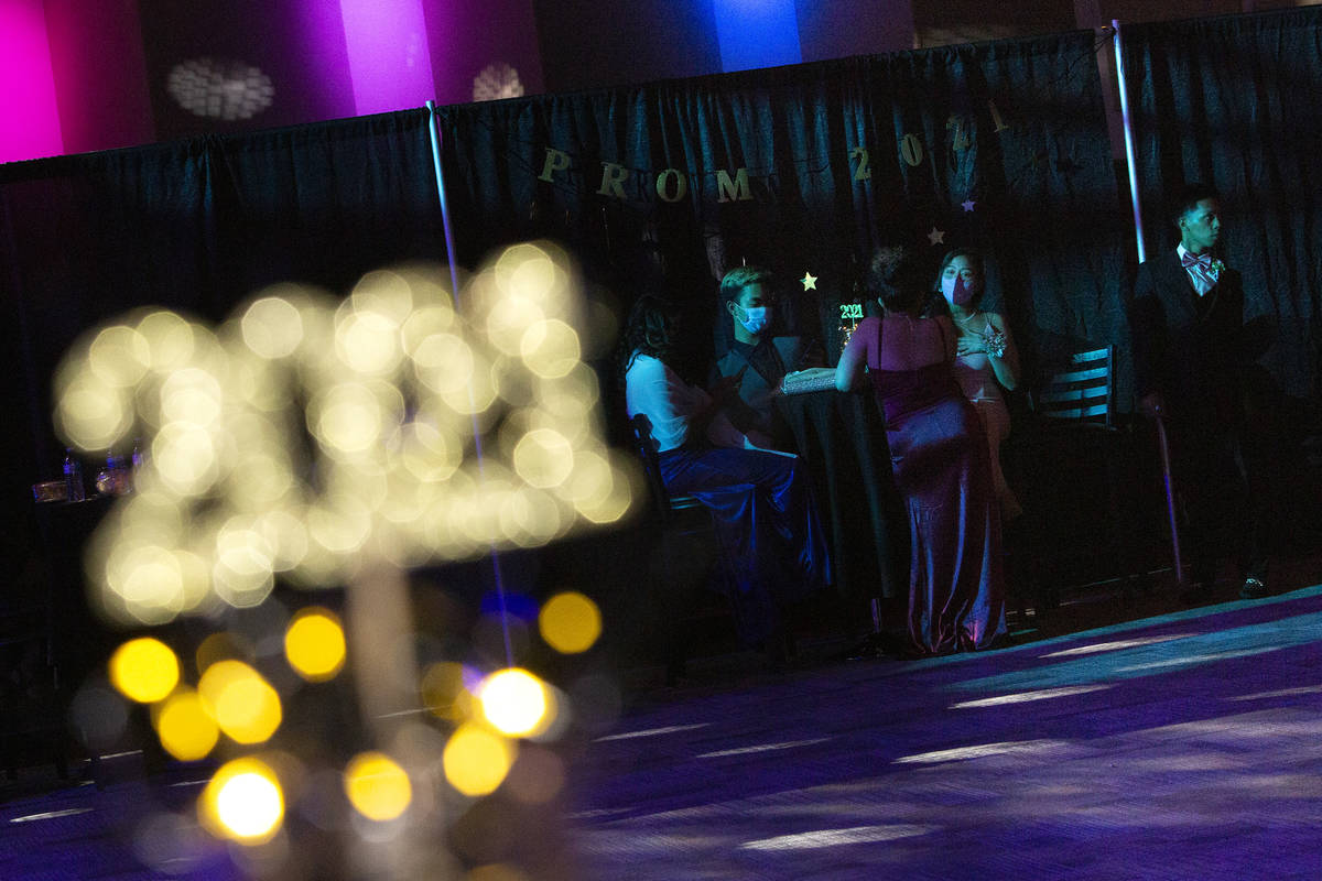 Students take a break from dancing at a prom for Clark County School District juniors and senio ...