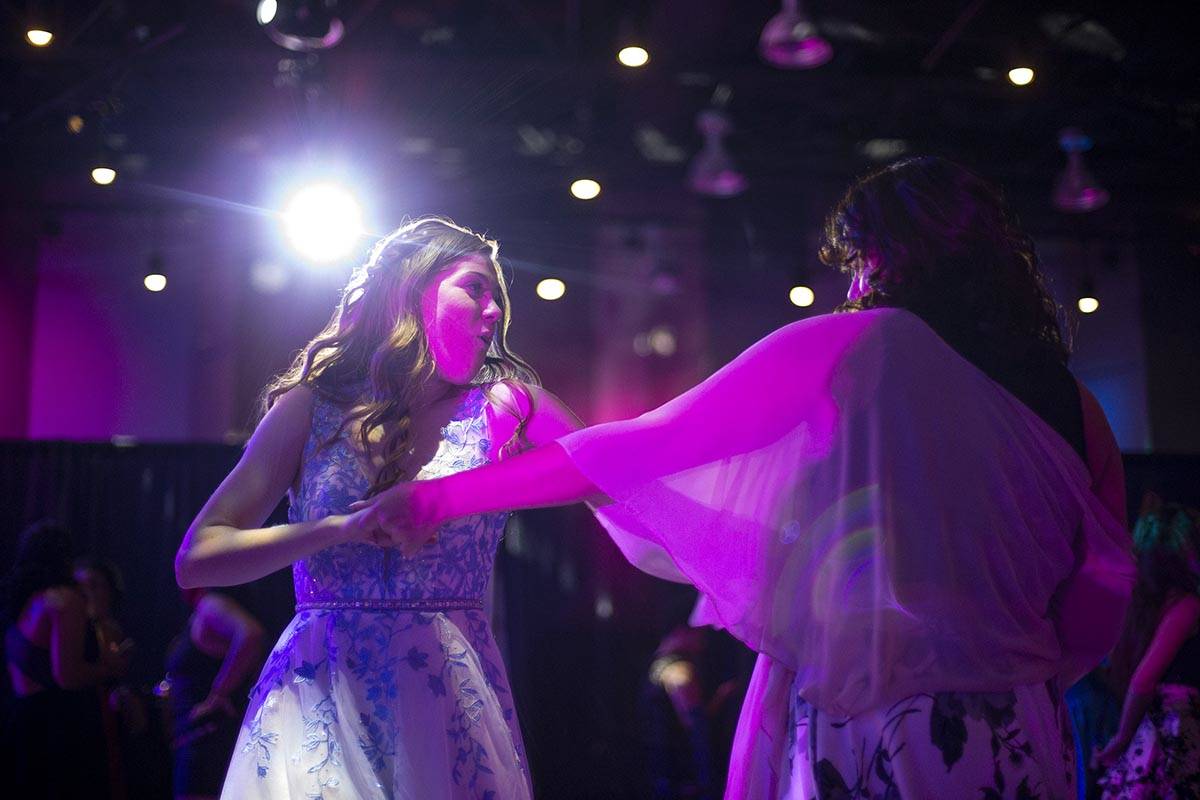 Cayna Love, left, and Renn Evans, both seniors at Coronado High School, dance during a prom for ...