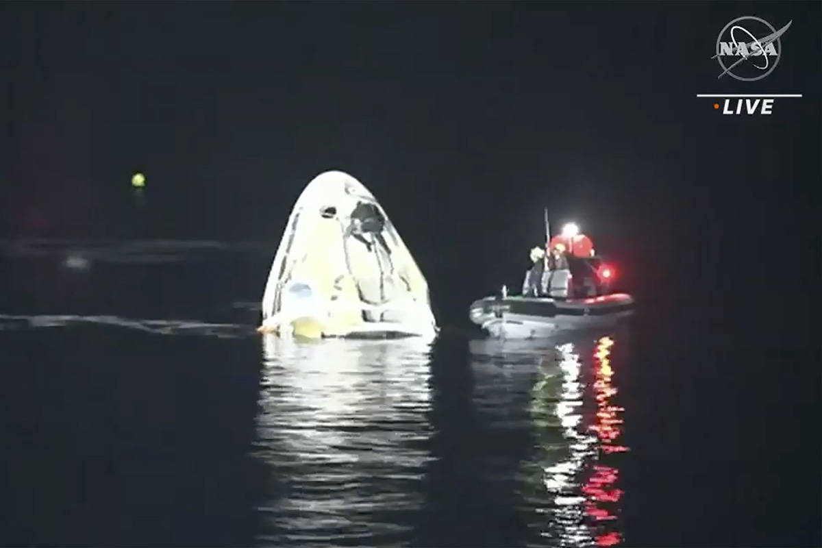 In this image made from NASA TV video, the SpaceX Dragon capsule floats after landing in the Gu ...