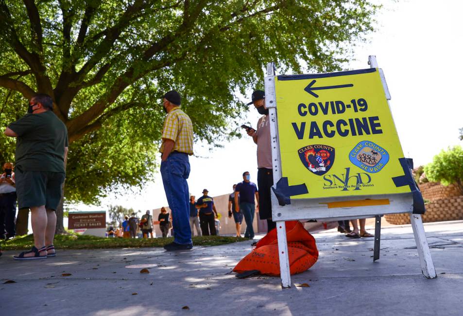 People wait in line at the COVID-19 vaccination site at Cashman Center in Las Vegas on Tuesday, ...