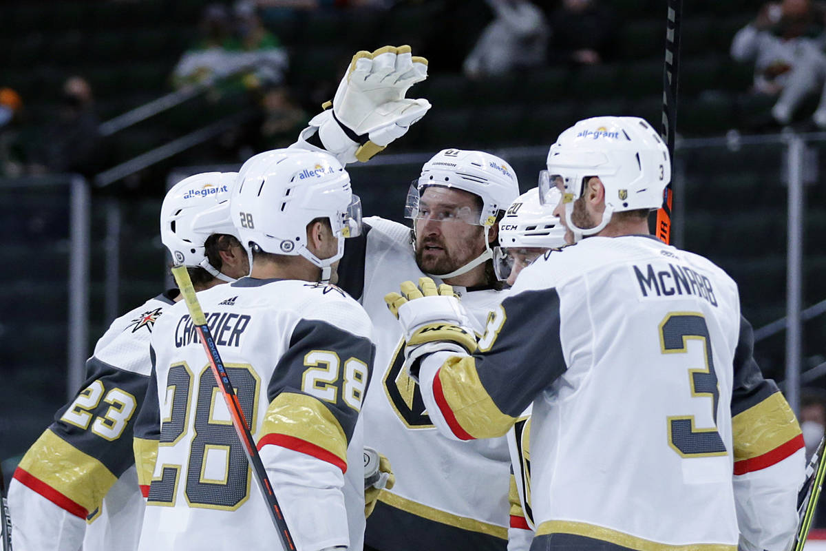 Vegas Golden Knights right wing Mark Stone (61), center, is congratulated by teammates after sc ...