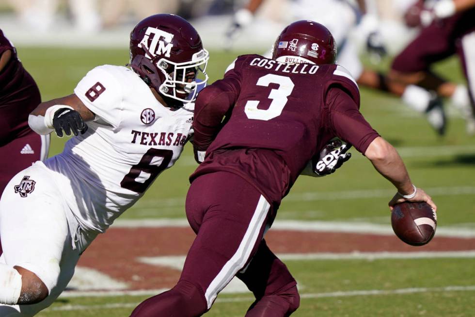 Texas A&M defensive lineman DeMarvin Leal (8) sacks Mississippi State quarterback K.J. Costello ...
