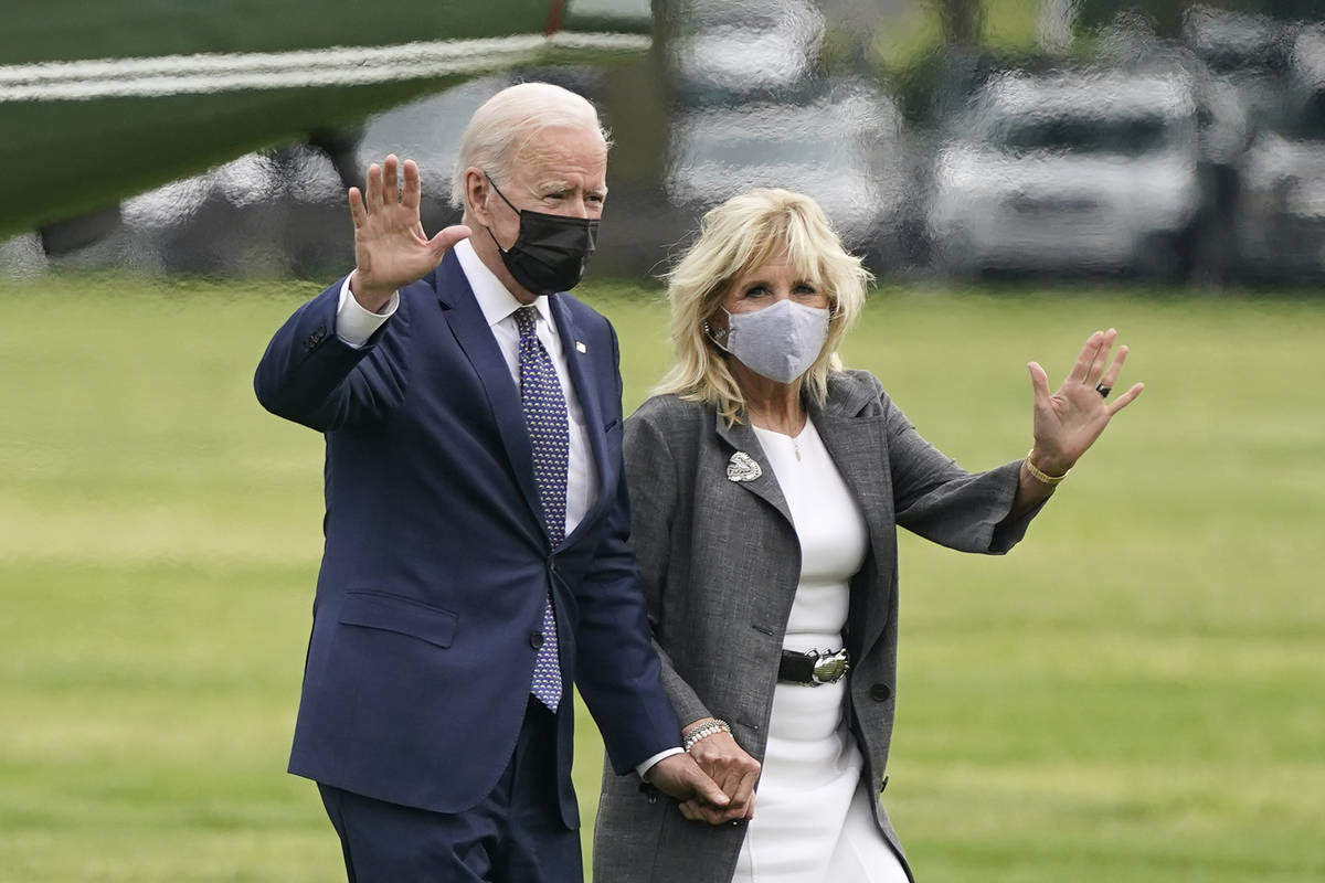 President Joe Biden and first lady Jill Biden wave after stepping off Marine One on the Ellipse ...
