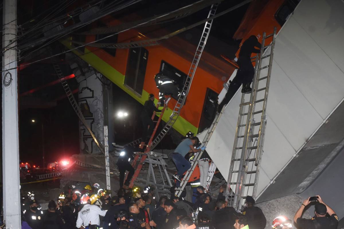 Mexico City fire fighters and rescue personnel work to recover victims from a subway car that f ...