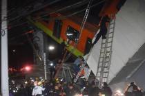 Mexico City fire fighters and rescue personnel work to recover victims from a subway car that f ...