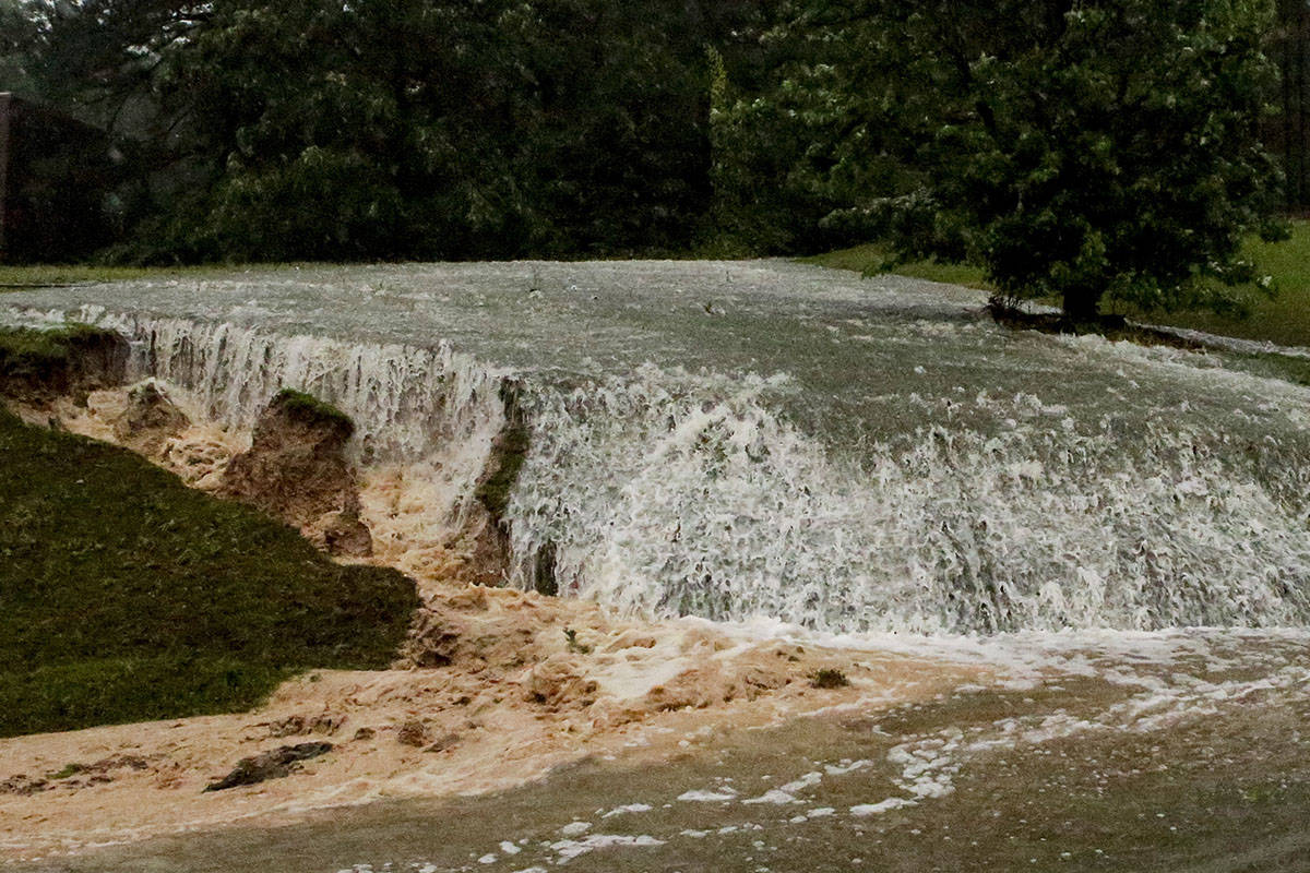 A hillside is eroded away as torrential rainfall falls Tuesday, May 4, 2021 in Vestavia, Ala. ( ...