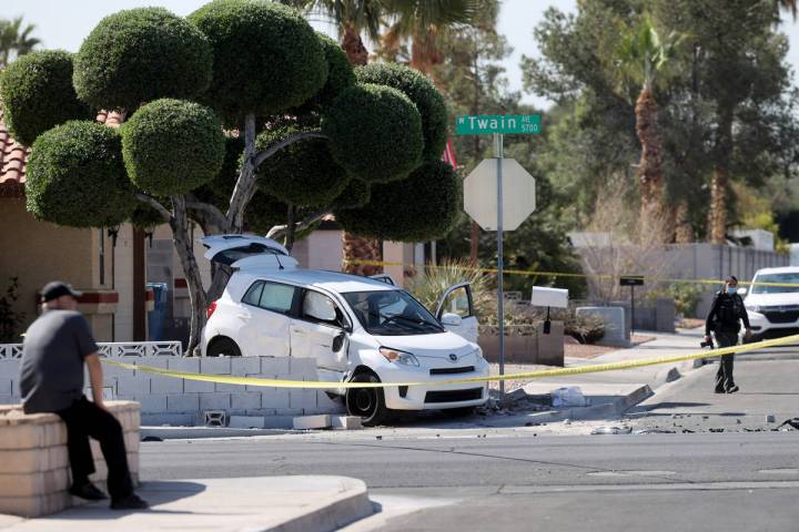 Las Vegas police investigate at the scene of a three-vehicle crash on Twain Avenue near Jones B ...