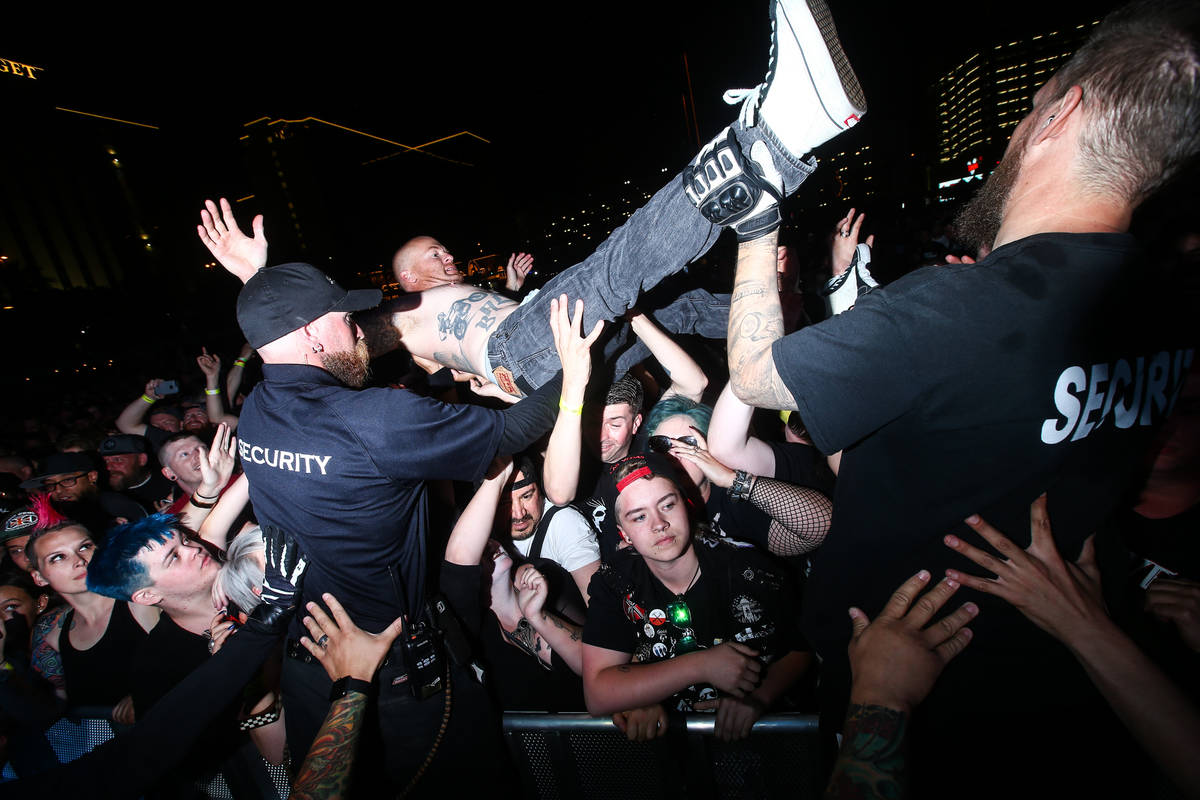 A crowd surfer is assisted by security as Suicidal Tendencies perform during the first day of t ...