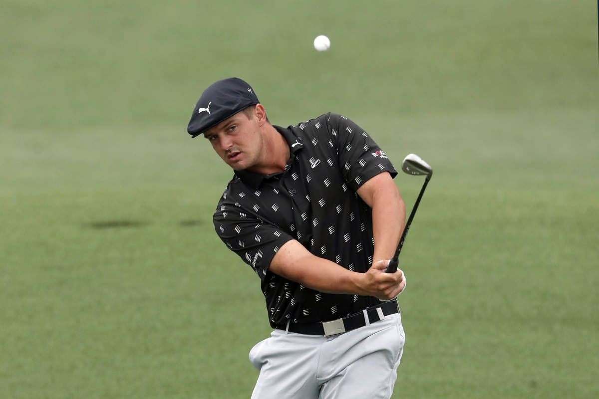 Bryson DeChambeau chips to the second hole during the third round of the Masters golf tournamen ...